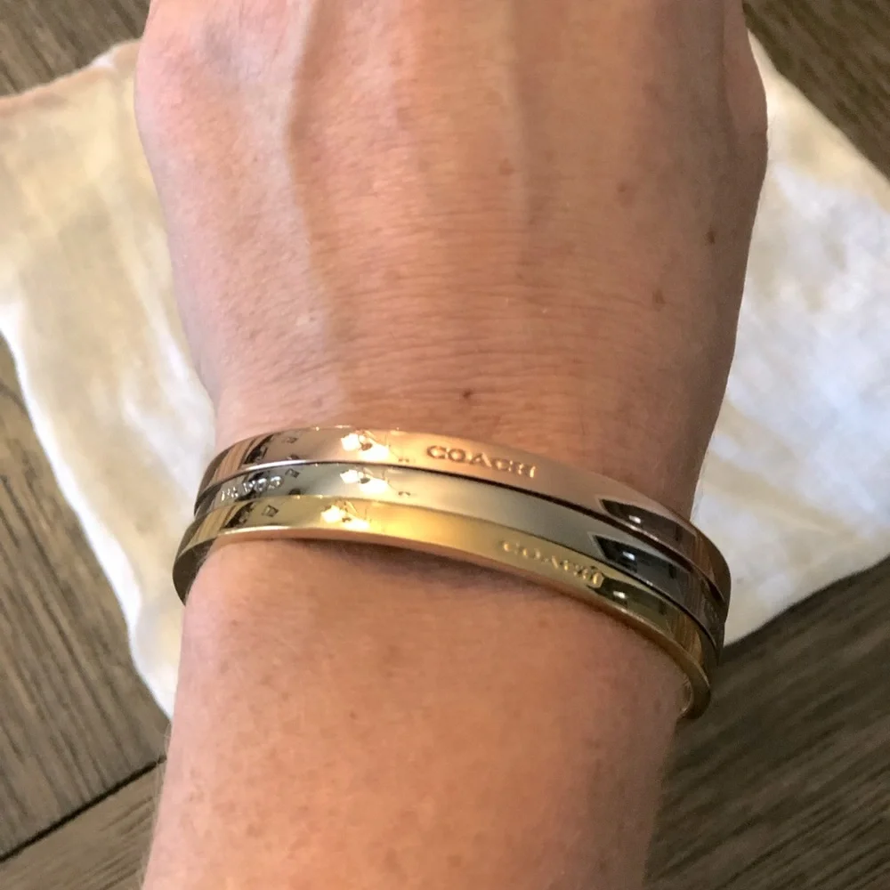 Coach bracelet set including a gold, silver and rose gold bangle. - Picture 1 of 3